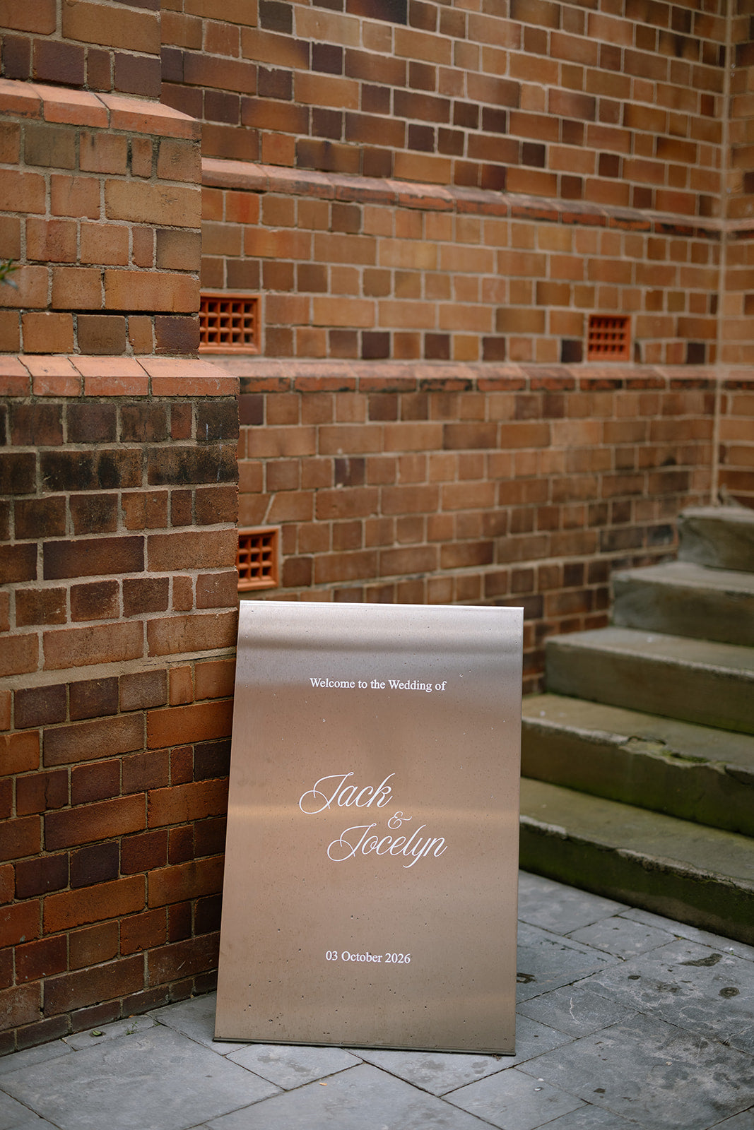 Brushed stainless steel A-frame welcome sign at a wedding