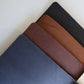 Navy, brown and black leather menus fanned