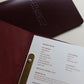 Burgundy leather menu open with a printed insert