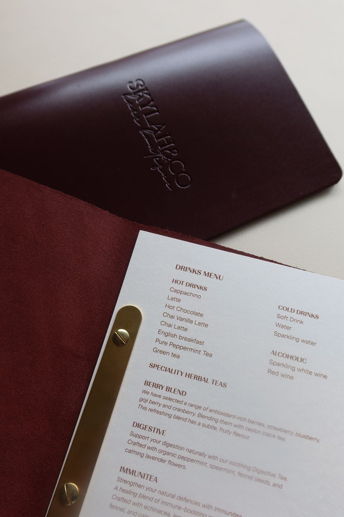 Burgundy leather menu open with a printed insert