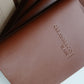 Brown leather menu with debossed name