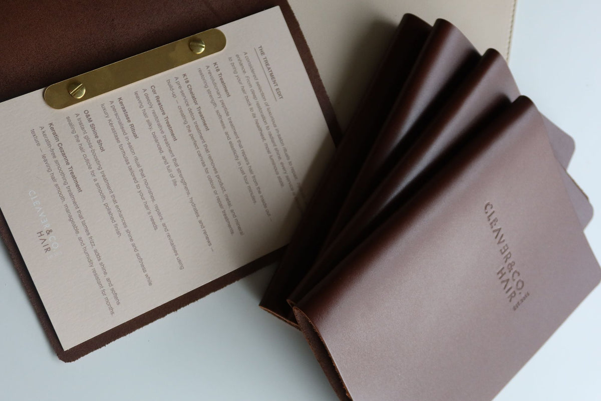 Brown leather menus with one open to a printed insert