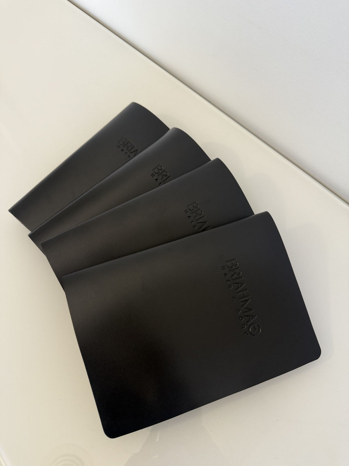 Black leather menus fanned
