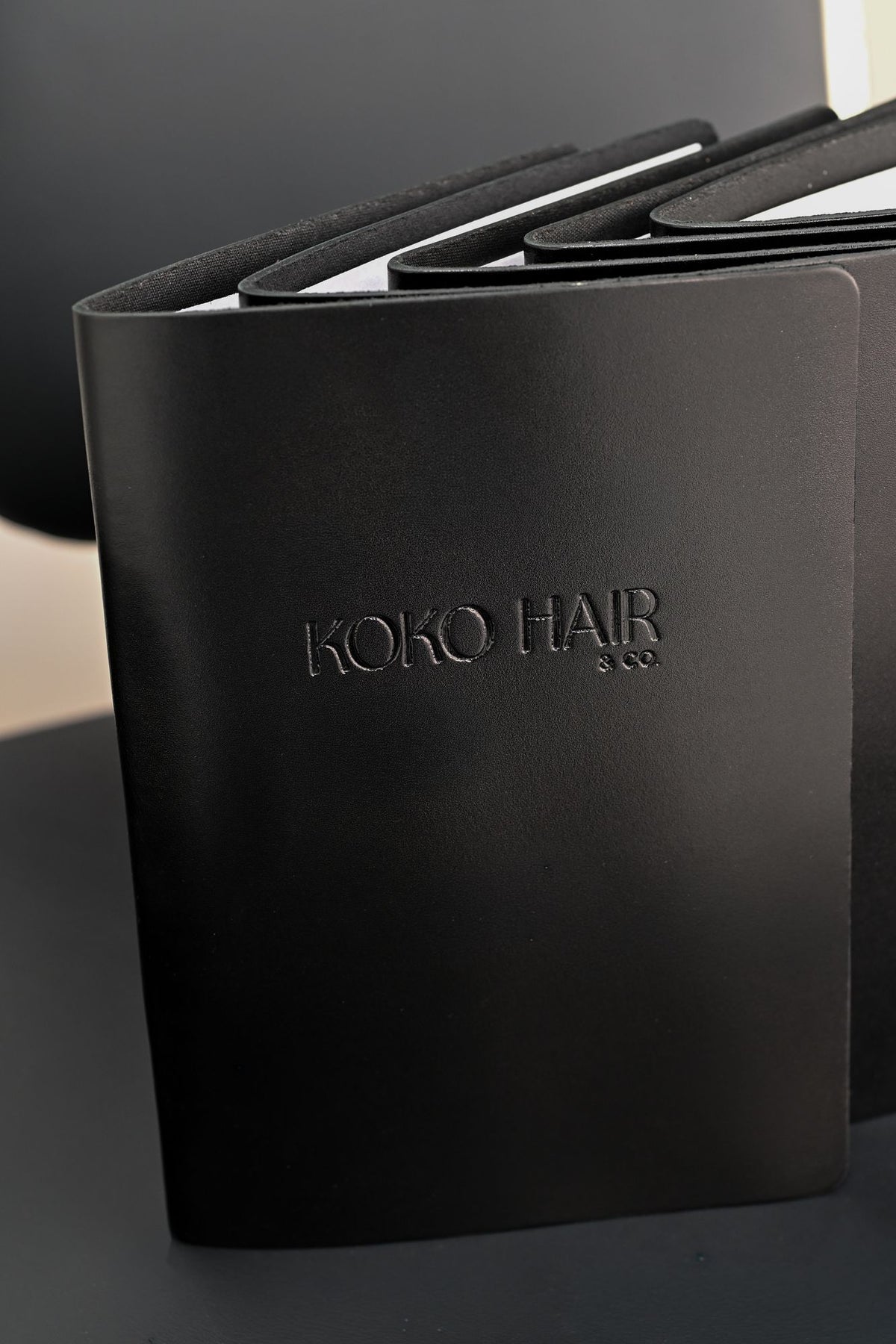 Standing black leather menu with debossed name